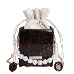 Brown snake embossed bucket bag with pearl handle and drawstring pouch detail
