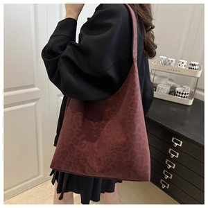 Model wearing a vintage leopard print tote bag in burgundy suede with a large capacity