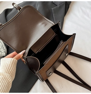 Detail view of large retro backpack with interior multi-layer storage and magnetic closure