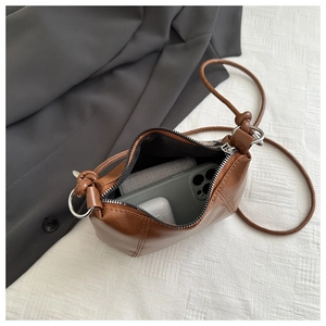 Top view of large brown crossbody bag showing spacious interior for phone and accessories