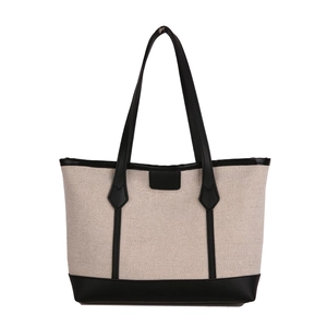 Minimalist canvas tote bag with black leather trim and contrasting stitching accents