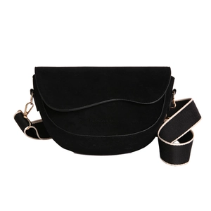 Minimalist black suede saddle bag with decorative stitching and wide textile strap