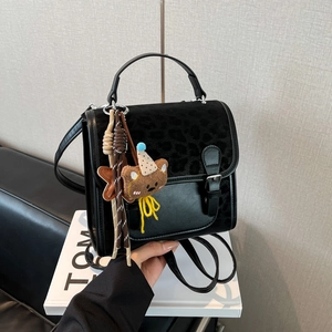 Black school style backpack with leopard print flap and cute bear pendant charm
