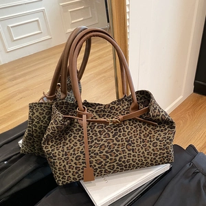Stylish large leopard print canvas tote bag with brown leather handles and buckle strap