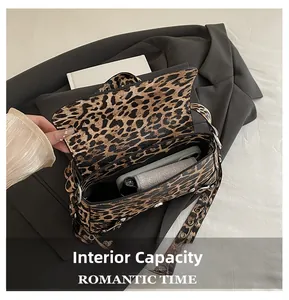 Detailed view of the leopard print crossbody bag showing its internal storage capacity