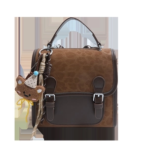 Retro leopard print handbag with brown leather trim and a cute plush bear pendant