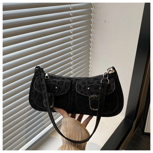 Close-up of black leopard texture underarm bag with double front buckle pockets