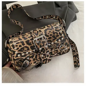 Detail of leopard print handbag featuring silver studs and a bold metal buckle closure