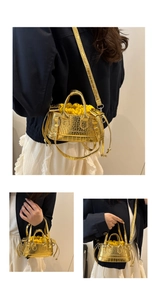 Detail of metallic gold mini bag with crocodile texture and yellow drawstring pouch
