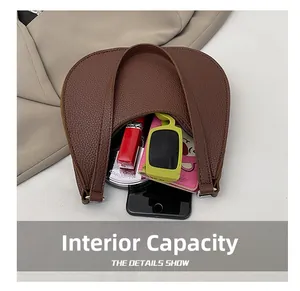 Interior view of brown lychee leather bag showing capacity for phone and cosmetics
