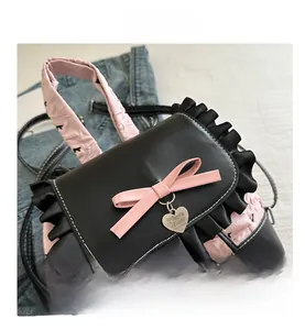Macro view of pink quilted fabric with leather bow and heart charm on a mini backpack