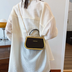 Fashionable black chain box handbag with gold metal trim and leather handle