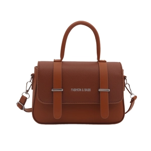 Brown leather crossbody bag with top handle and decorative metal buckles for women