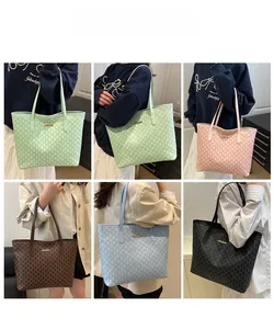 Detail view of large printed tote bags in five colors with repeated M patterns