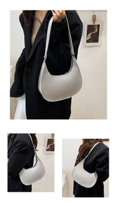 Detail showing the pebbled silver leather texture and half-moon shape of the hobo bag