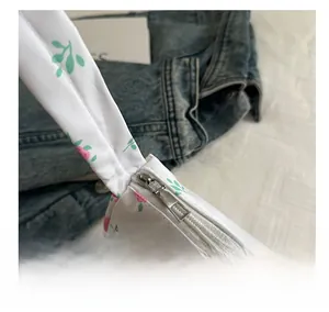 Close-up of smooth silver metal zipper on floral print polyester shoulder bag
