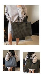 Detail of grey tote bag featuring letter M monogram print and black leather handles