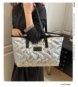 Detail of silver quilted tote bag showing high-capacity design and sleek metallic texture