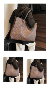Detail of vintage brown tote bag showing large capacity and M-letter monogram pattern