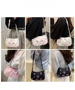 Detail shots of floral strawberry canvas shoulder bags in multiple colors with zip closure
