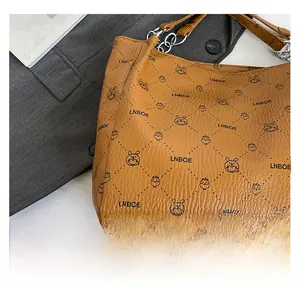 Detailed macro view of the brown textured leather surface and cute cartoon animal print