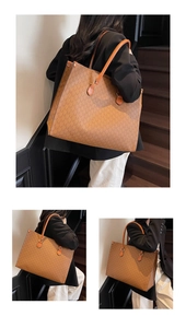 Close-up of the vintage brown leather tote bag with monogram pattern and long handles
