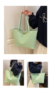 Detail view of mint green tote bag featuring luxury letter print and metallic logo