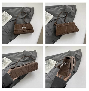 Macro views of brown pleated PU leather shoulder bag with vintage texture and silver buckle