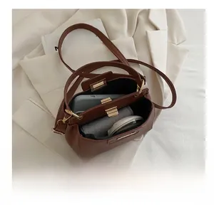 Internal view of brown litchi leather bucket bag showing capacity for phone and makeup