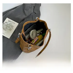 Spacious interior of brown printed tote bag showing daily essentials like tablet and umbrella