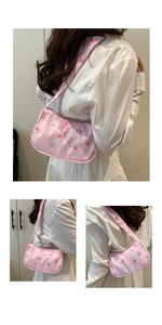 Close-up of pink floral pattern and drawstring texture on large shoulder underarm bag