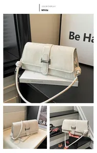 Detail of white baguette bag with marble texture, silver metal buckle, and knot strap