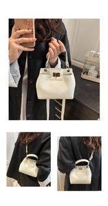 Detail of white lychee pattern leather crossbody bag with elegant gold metal lock buckle