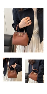 Detail of brown litchi pattern leather bag showing gold twist lock and shoulder strap