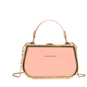 Pink trapezoidal box handbag with gold metal trim and chain strap on white background