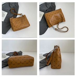 Detail view of brown monogram tote bag with vintage bear print and metal chain strap