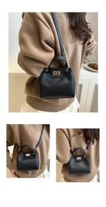 Detail of lychee pattern leather handbag with gold square lock and shoulder strap
