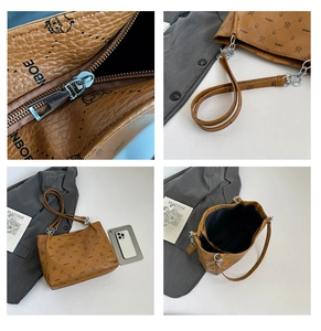 Detail of brown tote bag showing lychee leather texture, zipper, and chain strap details