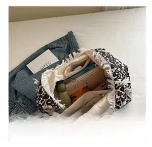 Detailed interior of leopard print tote bag showing large capacity and zipper pocket