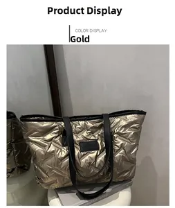 Detail of quilted metallic gold tote bag with black shoulder strap and square logo patch