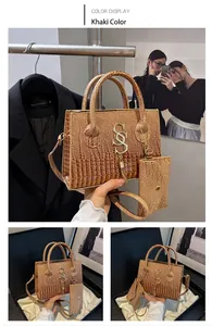 Detailed close-up of khaki crocodile pattern faux leather handbag set with metal S logo