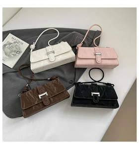 Group shot of wrinkled leather shoulder bags in white, pink, brown and black with buckles