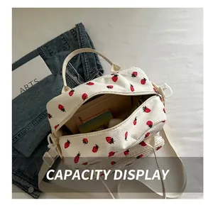 Internal capacity of white corduroy shoulder bag with strawberry print and zipper