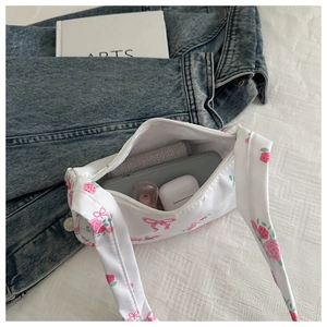 Detail shot of the floral handbag interior showing storage for phone and accessories