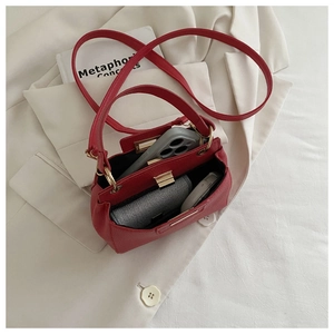 Top view of red lychee leather bucket bag showing internal space for phone and wallet