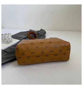 Detail of brown litchi leather handbag with LNBOE logo and vintage rabbit pattern