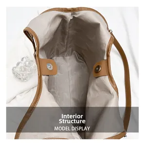 Detailed interior of brown leather tote bag with herringbone lining and magnetic clasp