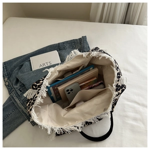 Inside view of leopard print tote bag showing zipper pocket, inner slots and large capacity