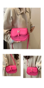 Detail of pink saddle bag featuring gold H-shaped buckle and leather shoulder strap
