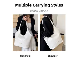 Detail of white woven hobo bag showing fine texture and dual shoulder or hand carry style
